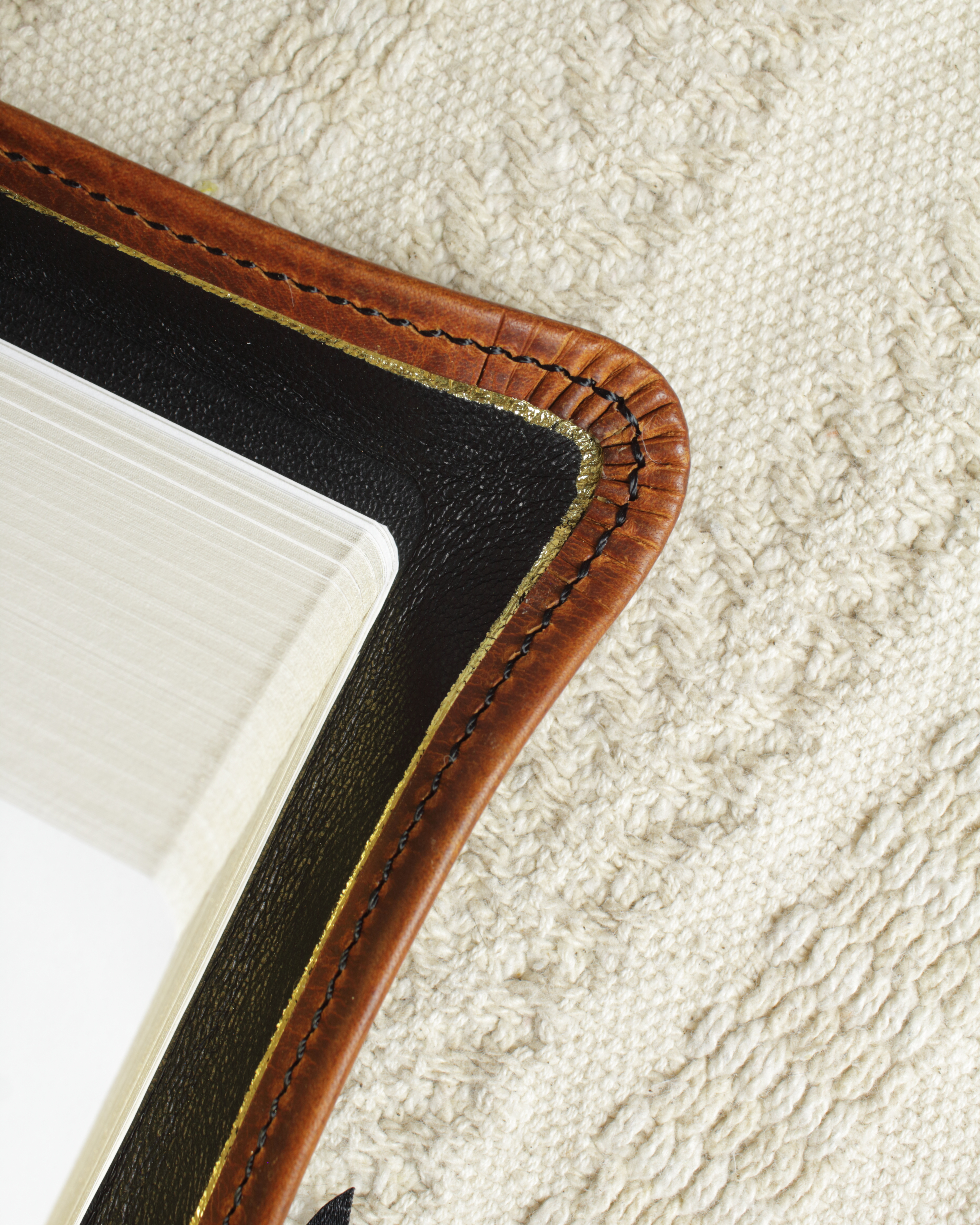 Close-up of perimeter stitching around a brown leather Bible cover